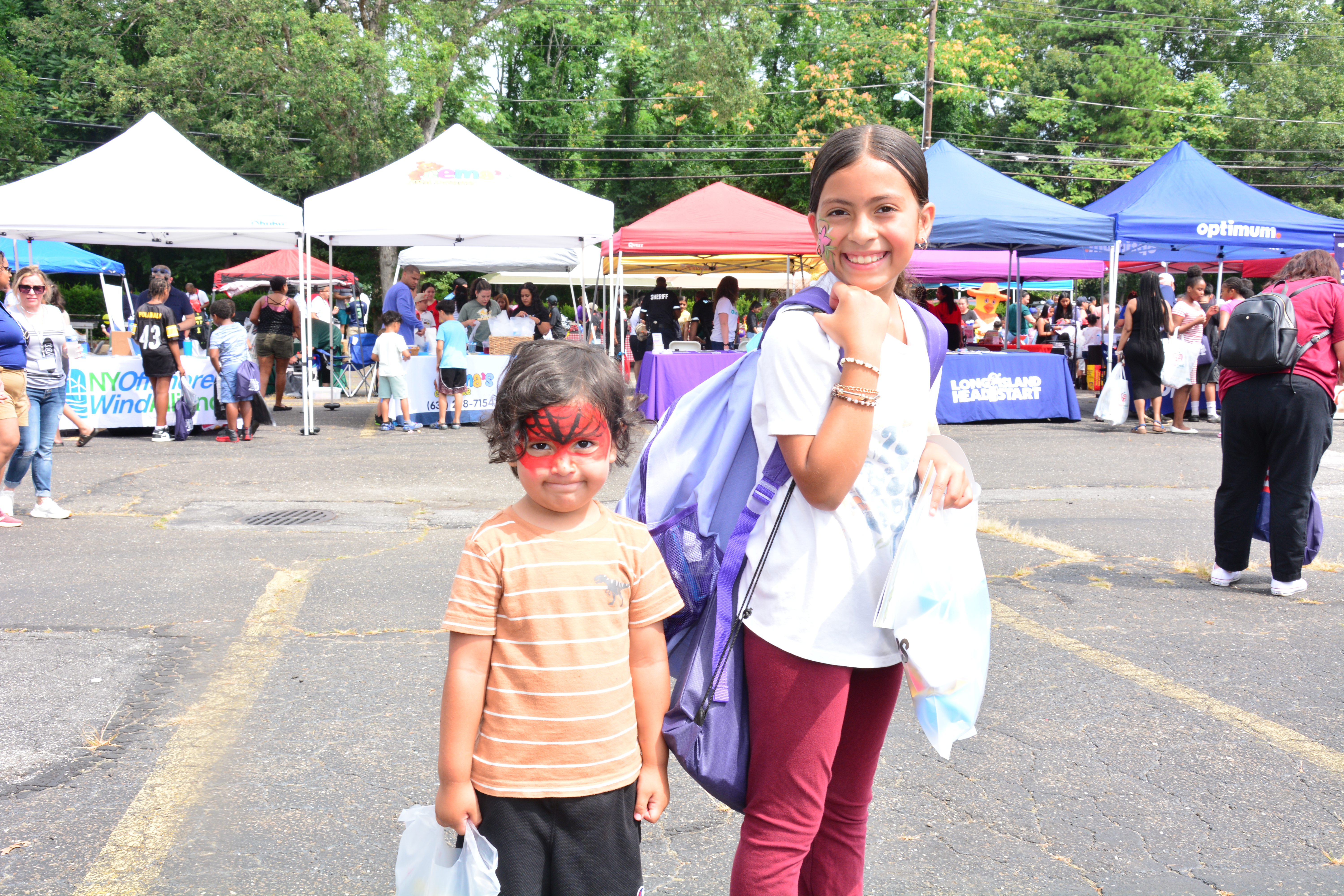 Photo of two children with backpacks at a school supply distribution event in Brentwood on Aug. 16, 2025.