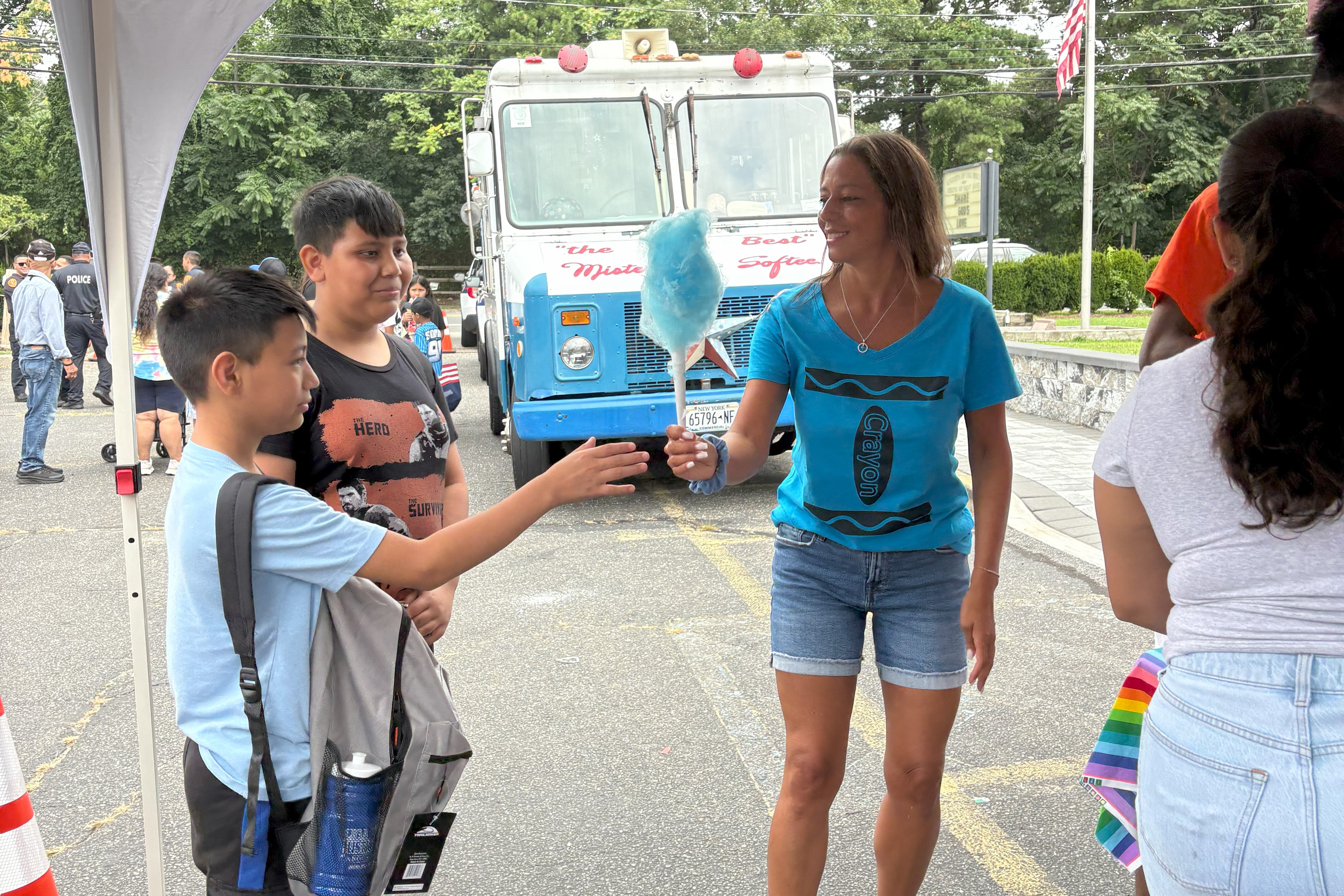 Sen. Martinez hands Cotton Candy out during a school supply distribution event on Aug. 16, 2025.