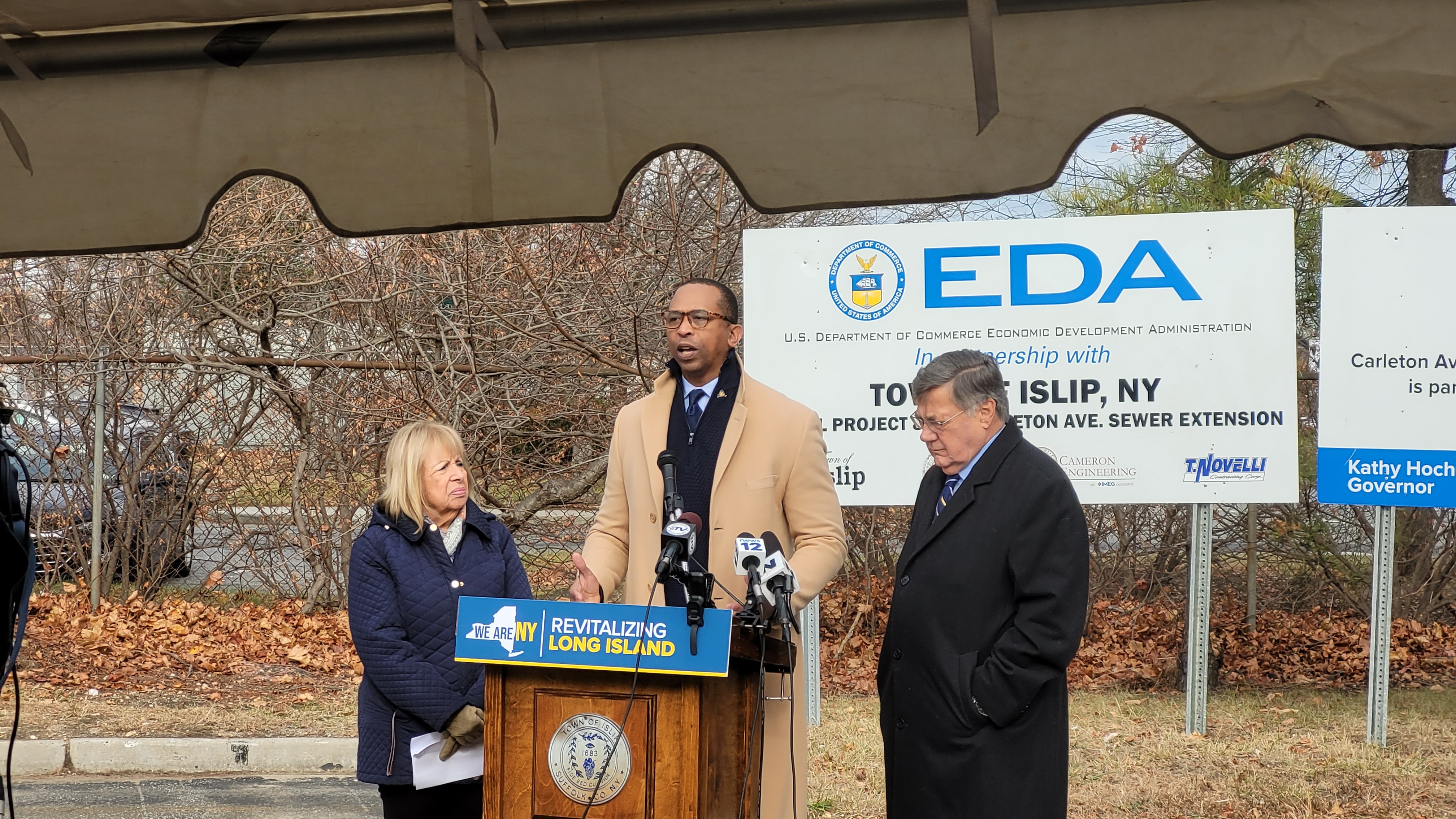 New York Secretary of State Walter T. Mosley (center), announces completion of the Carleton Avenue sewer expansion project during a press conference on December 3, 2024 with Islip Town Supervisor Angie Carpenter (left) and Suffolk County Executive Edward P. Romaine (right) in Central Islip, N.Y.