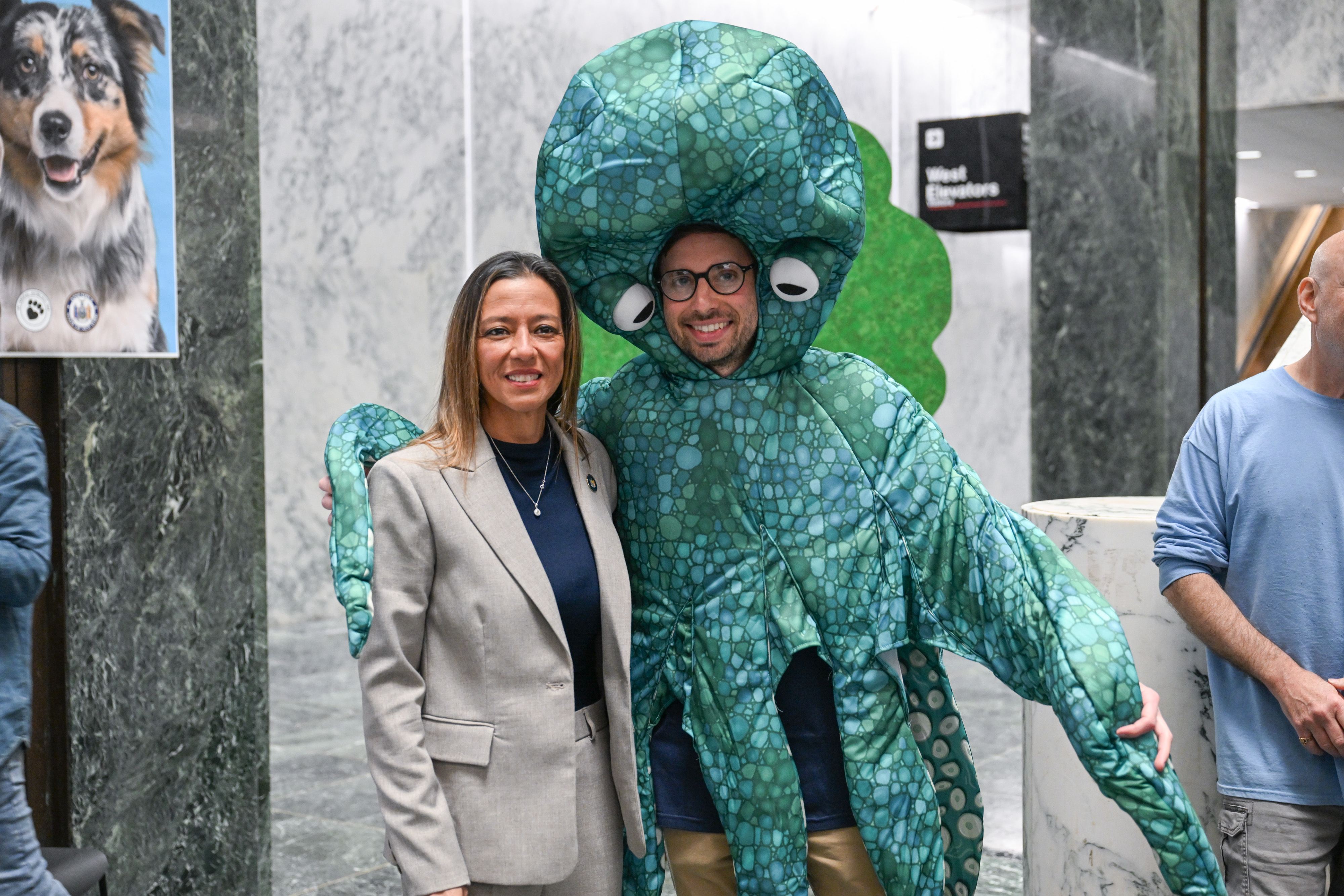 NYS Senator Monica R. Martinez stands next to a person wearing an Octopus costume on Animal Advocacy Day.