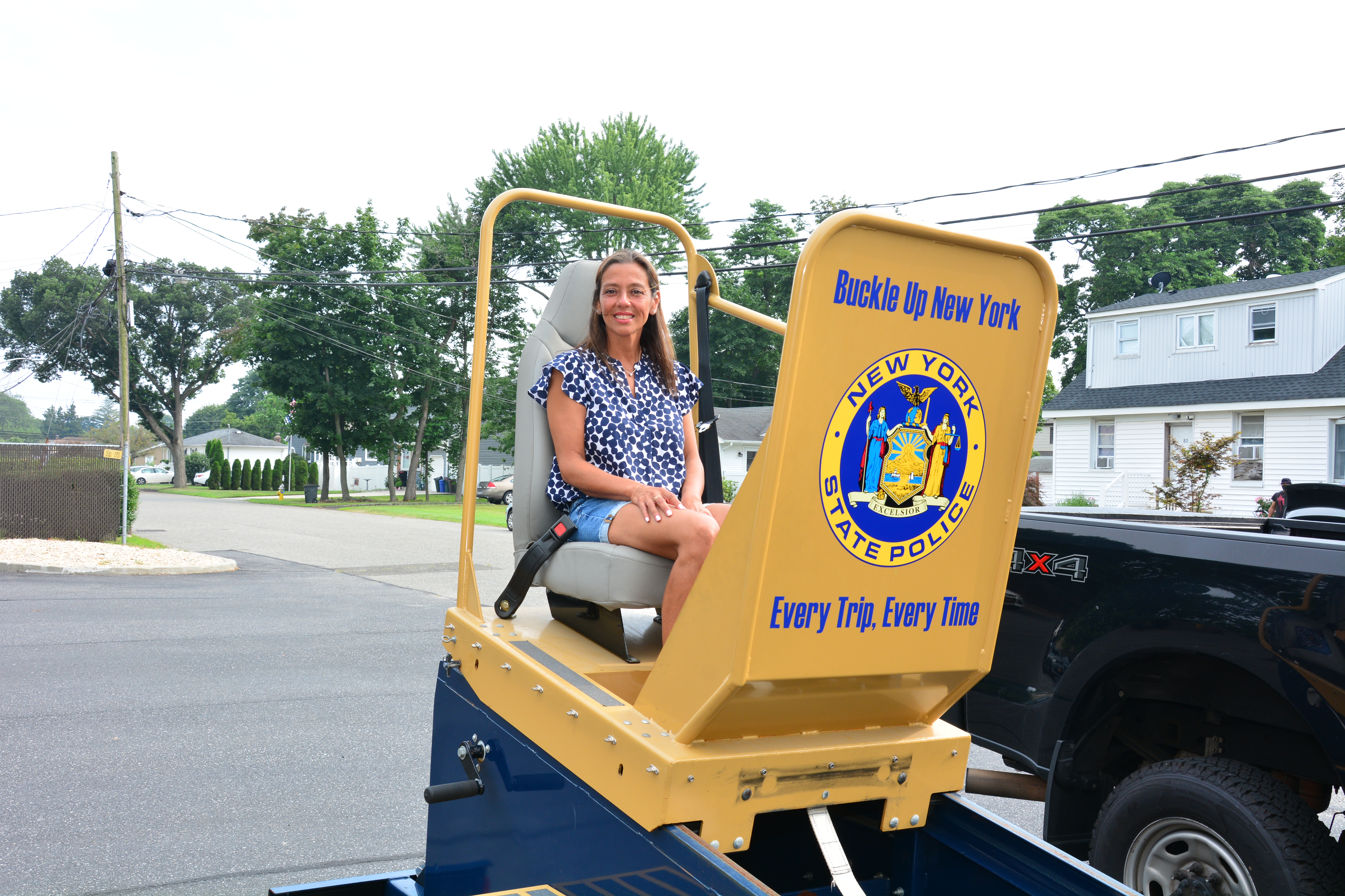 New York State Sen. Monica R. Martinez tries out a seat-belt safety demonstration machine during an event held on July 26, 2025 in Deer Park. 