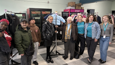Senator Toby Ann Stavisky standing with Commonpoint staff, volunteers, and recipients at the Winter Coat Drive in Tanenbaum Family Pool, Queens.