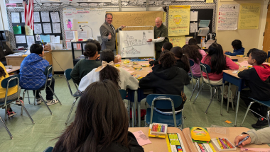 Senator Addabbo, left, joins artist Gennaro Kravitz as he demonstrates how to draw using basic geometric shapes.