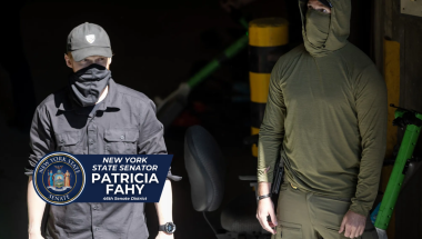 Two practically unidentifiable masked ICE agents