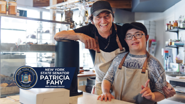 Employee with disabilities smiling with coworker at coffee shop/bakery