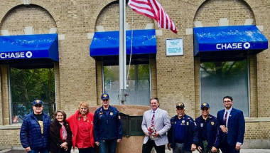 Senator Addabbo joins members of the American Legion Post 118 and Women's Auxillary to admire the newly flown flag.