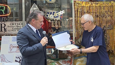 Senator Addabbo presents a certificate to Augusto Cerrone owner of American Shoe Service.