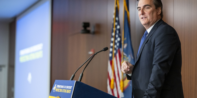 Senator Gianaris delivering remarks at a podium