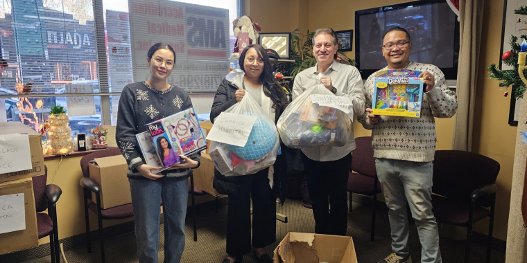 Resorts World Representatives collect toys to distribute to Jamaica Hospital.