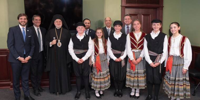 New York State Senator Andrew Gounardes, Senate Deputy Leader Michael Gianaris, His Eminence Archbishop Elpidophoros, Assemblyman Michael Tannousis, Assemblyman John Lemondes, and Senator James Skoufis with dancers in traditional costume at the Greek Independence event in Albany. Photo: Senator Gianaris' office