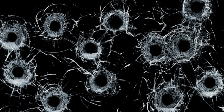 Bullet holes through glass.