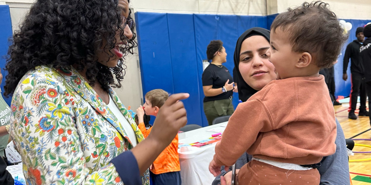 Senator Brouk greets baby