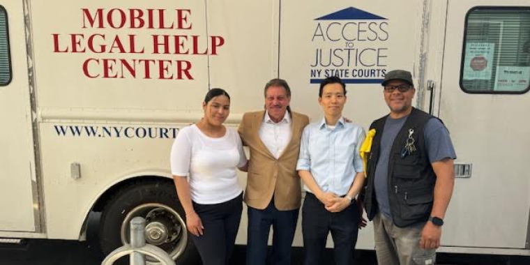 Senator Addabbo greets the NYLAG team (from left) Maria Barrientos, Senior Coordinating Paralegal, Luke Lee, Legal Intern, and driver Elliot Medina.