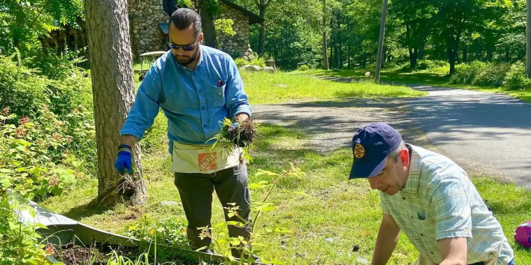 Senator Serrano planting at Camp Junior