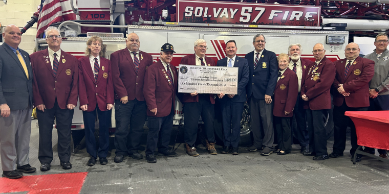 Senator Ryan and Volunteer Firefighters in front of a fire truck to present a $120,000 check