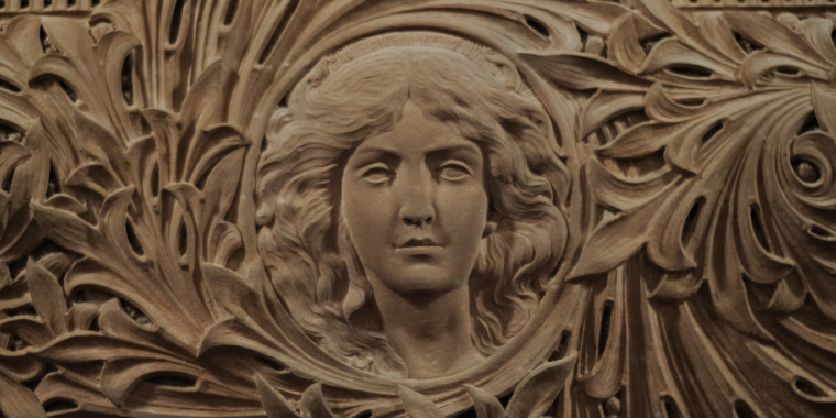 Stone relief of women in Senate Chamber.