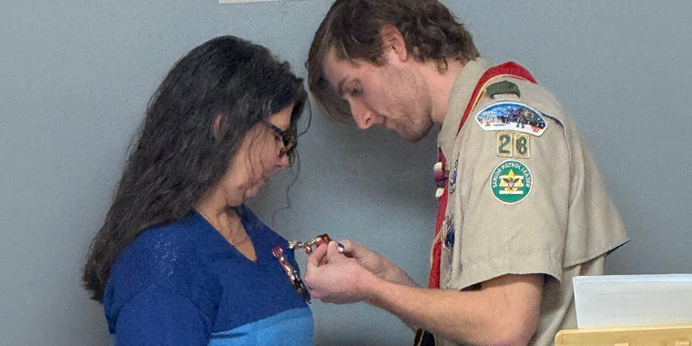 Eagle Scout Alder Frederick Bera proudly pins his mother with the Mother’s Eagle Pin.