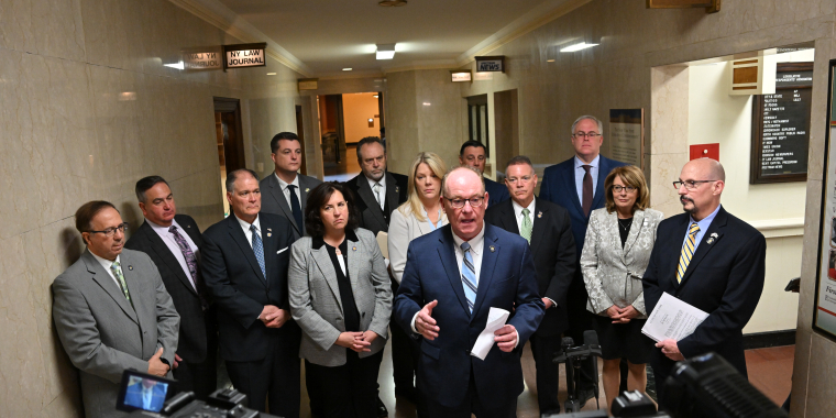 Senators standing in front of the Leg Correspondents Association offices
