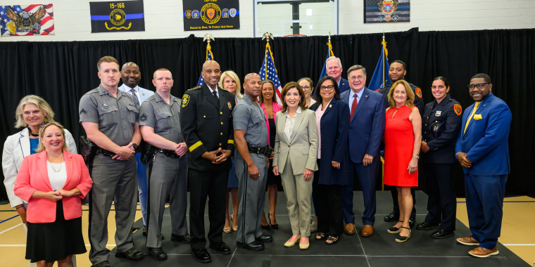 Photo - Attendees of GIVE Grant Announcement, including law enforcement officers and elected officials, stand for photo with governor in Brentwood. 