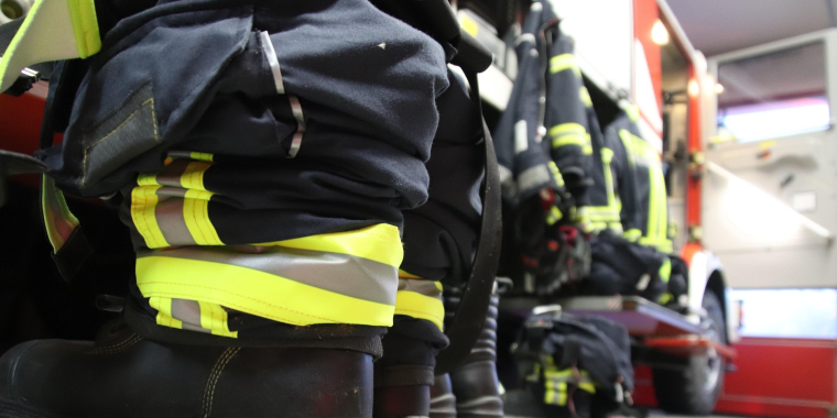 Photo Image of firefighter boots lined up next to a fire truck 