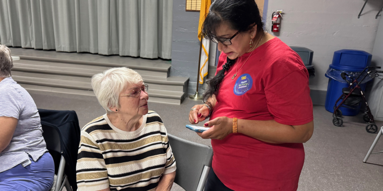 DMS President Darshani Kamini Singh helps one of the seniors with her phone.