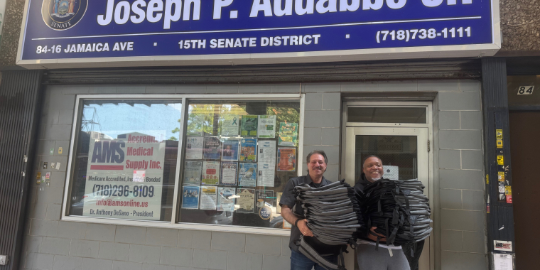 Senator Addabbo presents backpacks to Michael Bacchus of Full Gospel Assembly.