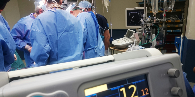 Photo image of hospital operating room with medical professionals at work.