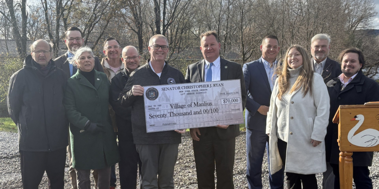 Group of people standing with a big check from Senator Christopher Ryan awarding $70,000 to the Village of Manlius