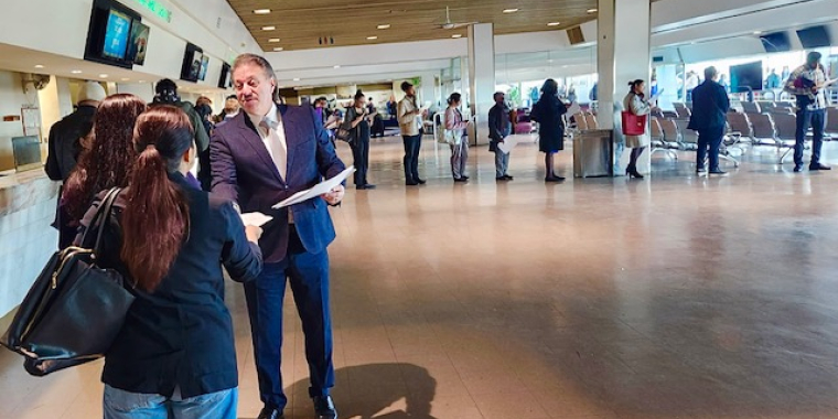 Senator Addabbo greets a job seeker while a long line of other attendees waits to explore the employment opportunities at the event.
