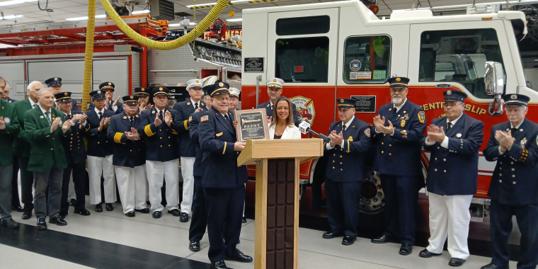 Photo of New York State Senator Monica R. Martinez receiving the Golden Trumpet award from FASNY President Eugene J. Perry Jr.