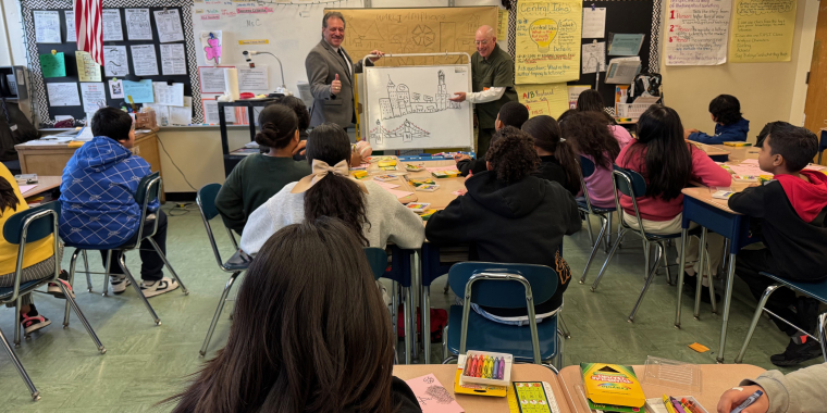 Senator Addabbo, left, joins artist Gennaro Kravitz as he demonstrates how to draw using basic geometric shapes.