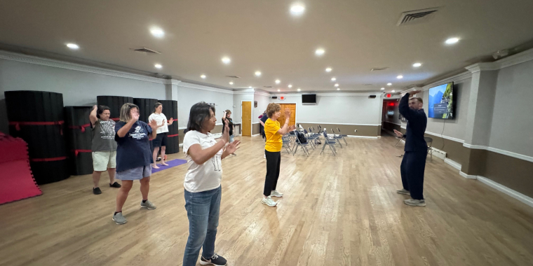 Sean Newman from Body and Brain leads the yoga and Tai class.