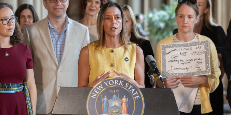 New York State Senator Monica R. Martinez speaks from a podium during a May 20, 2026, press conference with lawmakers and advocates calling for updated health curriculum covering common menstrual disorders.
