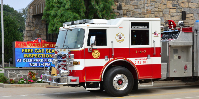 Photo of a Deer Park Fire Department Firetruck parked in front of the Deer Park Fire Department