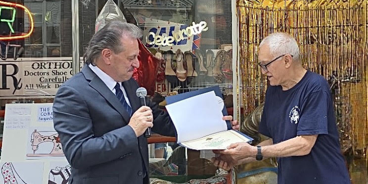 Senator Addabbo presents a certificate to Augusto Cerrone owner of American Shoe Service.