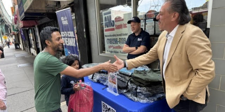 Senator Addabbo shakes hands with a constituent who was picking up school supplies.