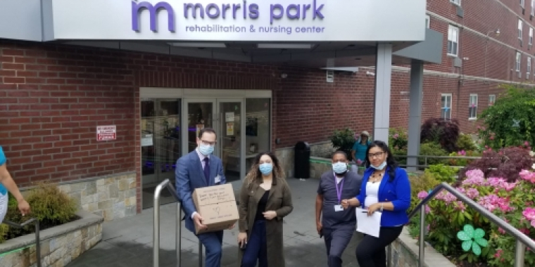 Team Biaggi poses in front of Morris Park Rehabilitation & Nursing Center