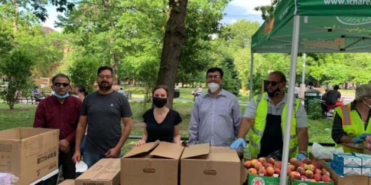 Team Biaggi stands with packaged meals 