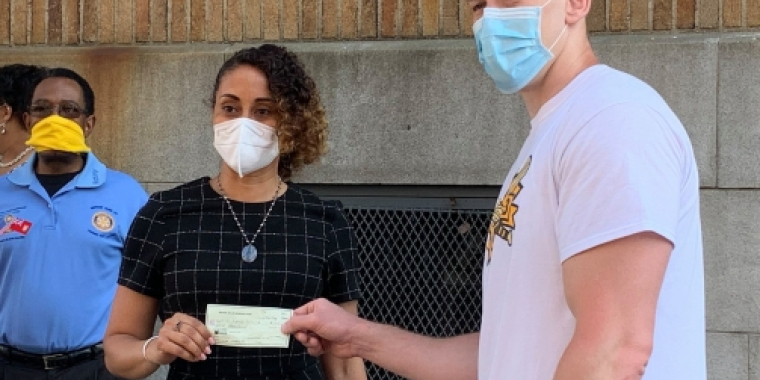 Team Biaggi takes a photo with a check 